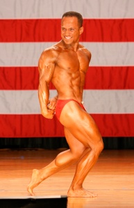 Side Triceps pose in the heat of competition at the 2007 World Natural Bodybuilding Contest held in NY, USA. Represented Australia. Ranked: 4th Best Natural Bodybuilder in the World. Repeated this in 2008.